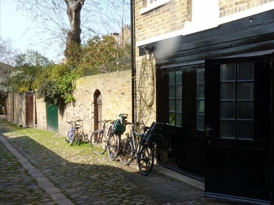 Coach house doors from living room that back into private mews 