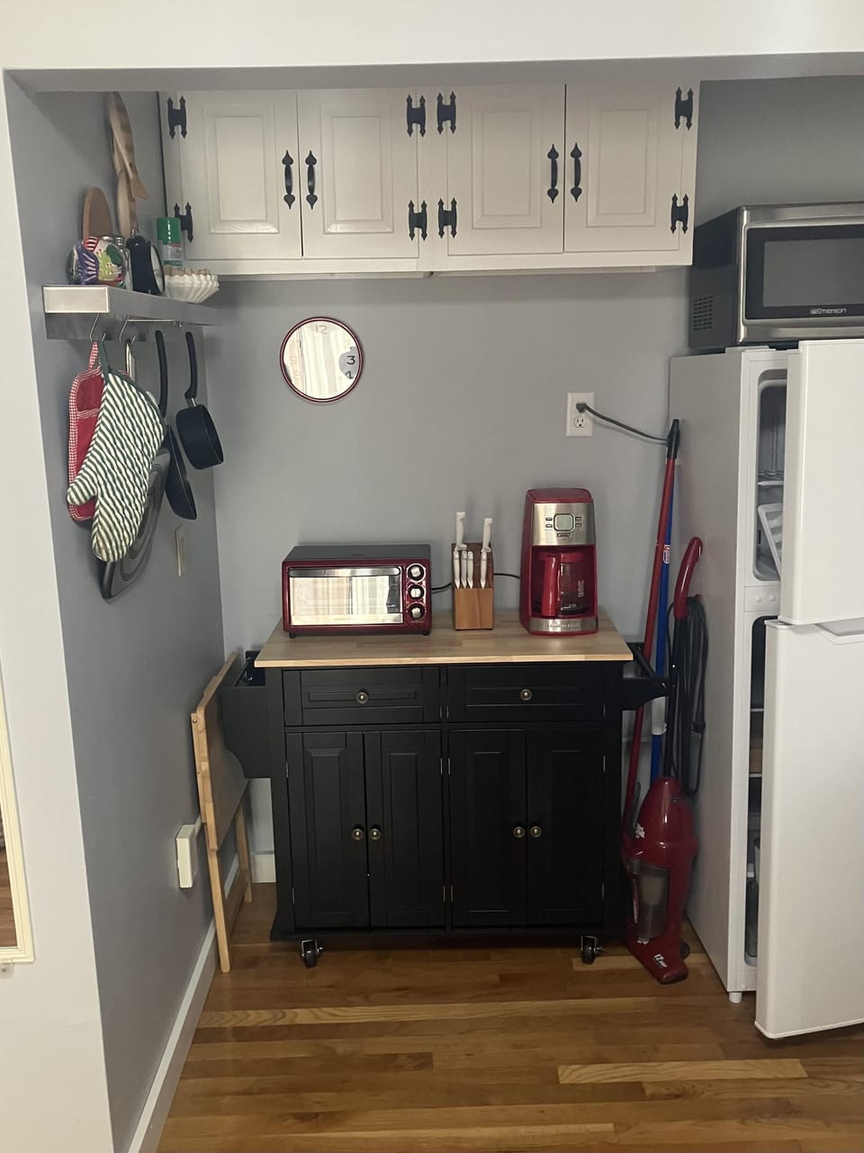 Cozy kitchenette with modern appliances and warm wood floors