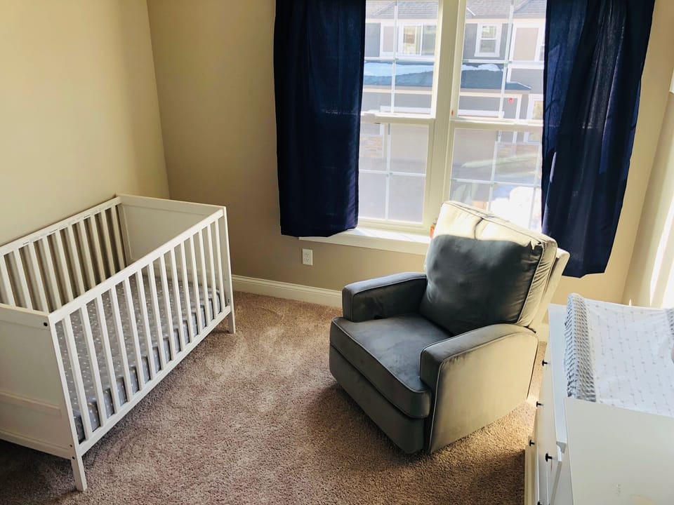 Nursery with a crib, rocker and changing table