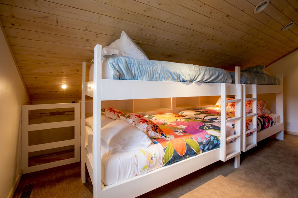 Bunkroom with 2 queens and 2 twins. Photo taken before safety rail installation.