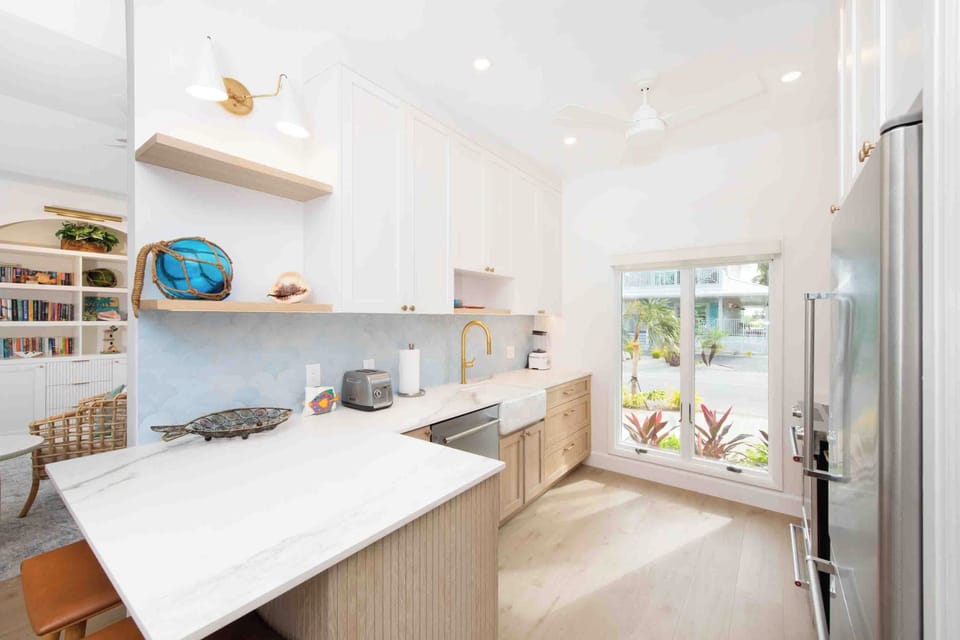 Modern kitchen with countertop appliances including a toaster and blender. A drip coffee maker is included with the home. 