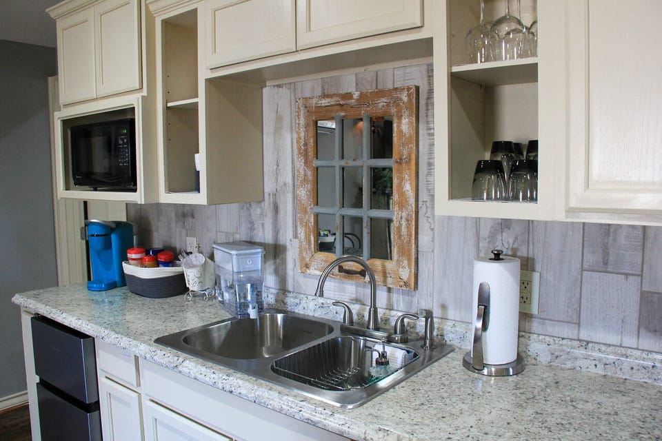 Keurig coffees and creamer along with snack and wintered water.