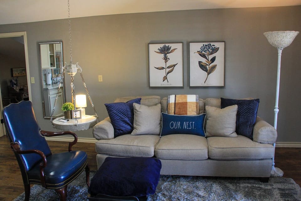 Comfy living space with kitchenette and large smart tv.