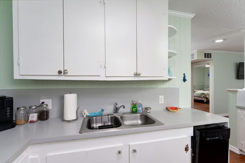 Your fully equipped kitchen features crisp white cabinets, granite counters, and everything needed for meal prep during your stay.