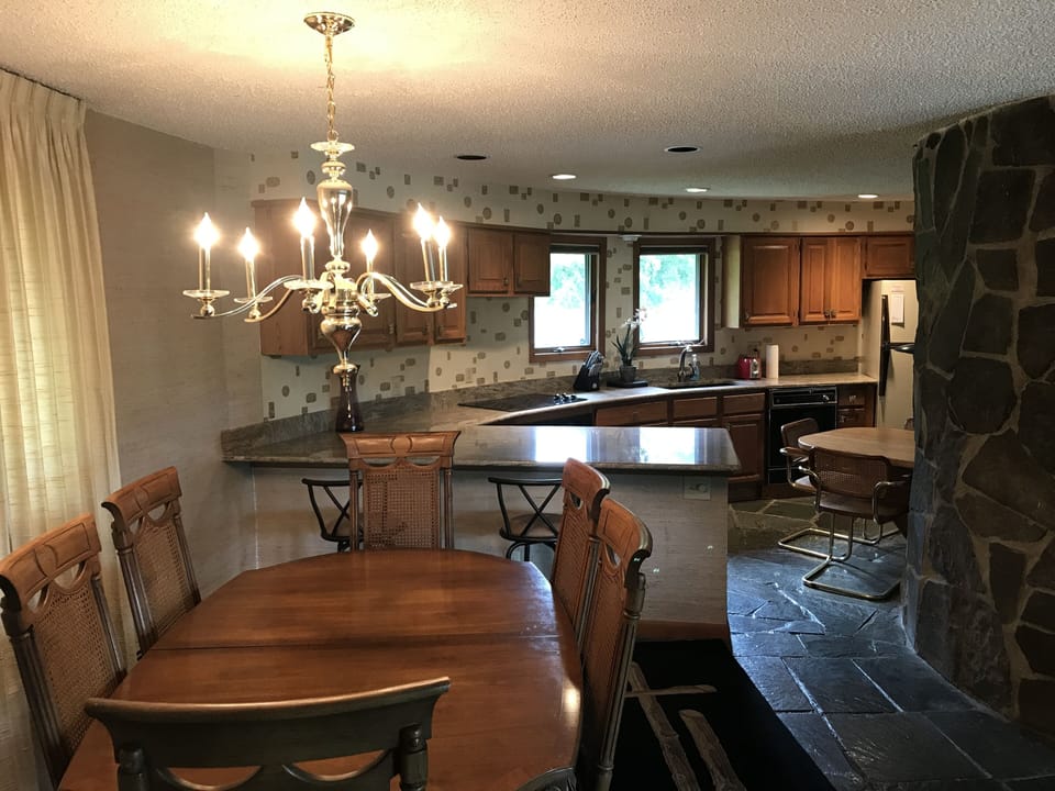 Dining room table seats six, with extensions for up to ten