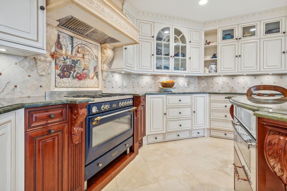 Mosaic backsplash above the royal-blue oven