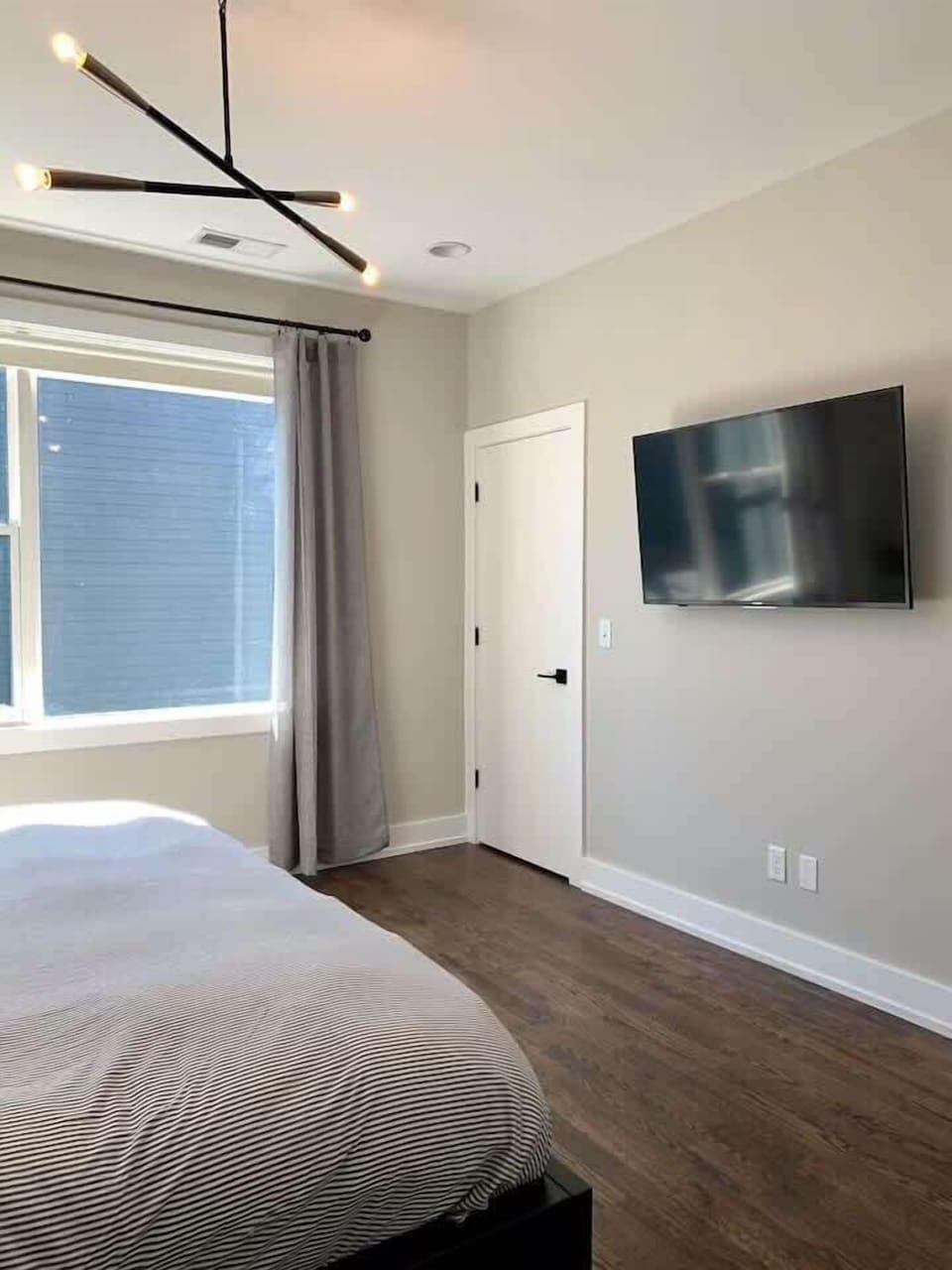 Unit 2 - The master bedroom features a 55" SmartTV and blackout roller blinds Perfect for relaxing after a late night out on Broadway!