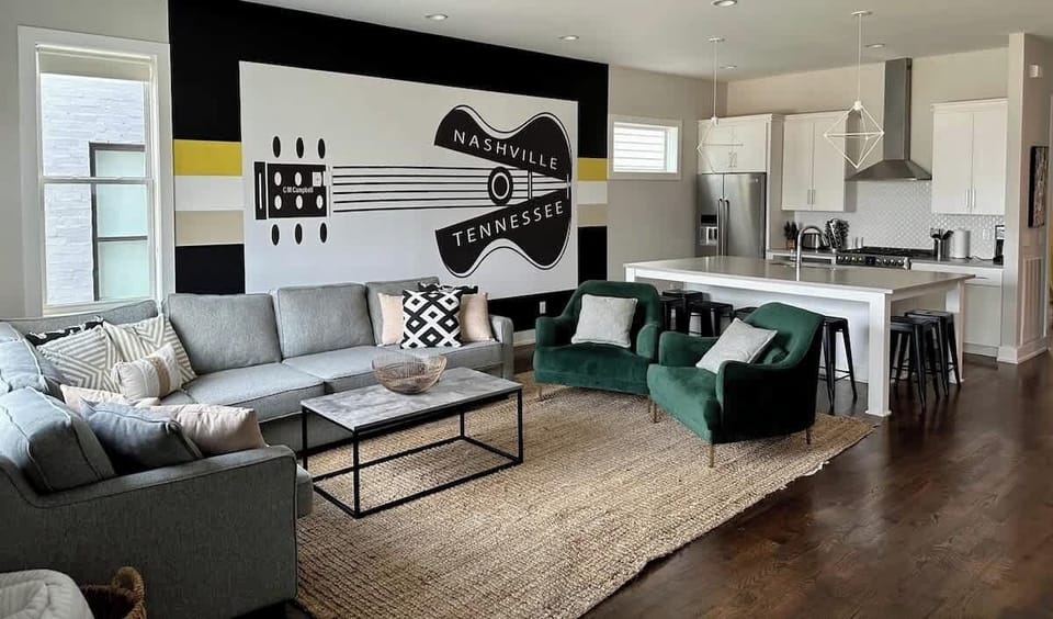 Unit 2 - Large open living room with custom sectional and comfy club chairs. The light filled living room can easily transform into the perfect place for movie night with the blackout shades and 65" HD SmartTV.