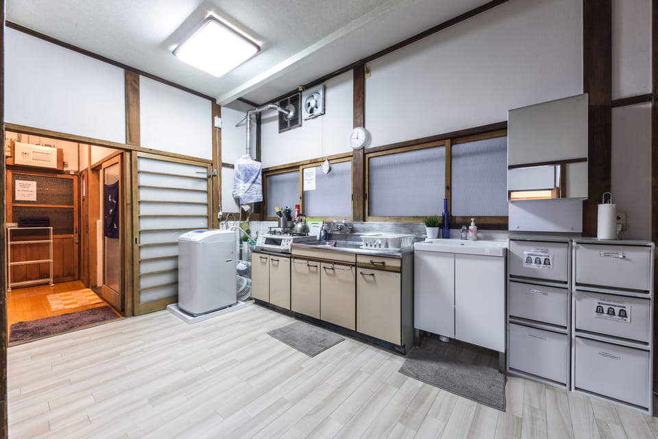 Spacious communal kitchen with washer and practical amenities