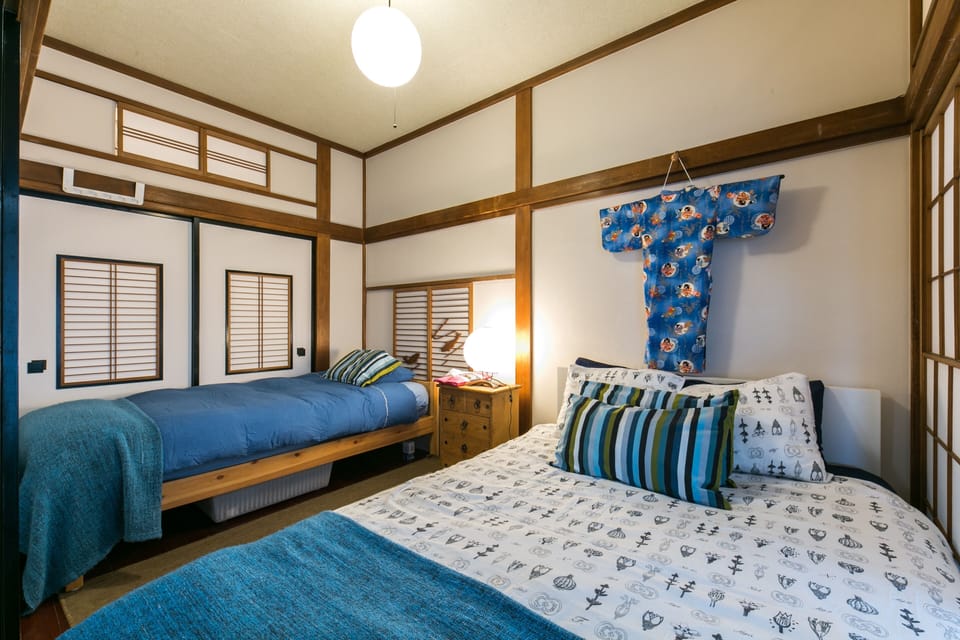 Stylish bedroom with twin bedding and traditional kimono art