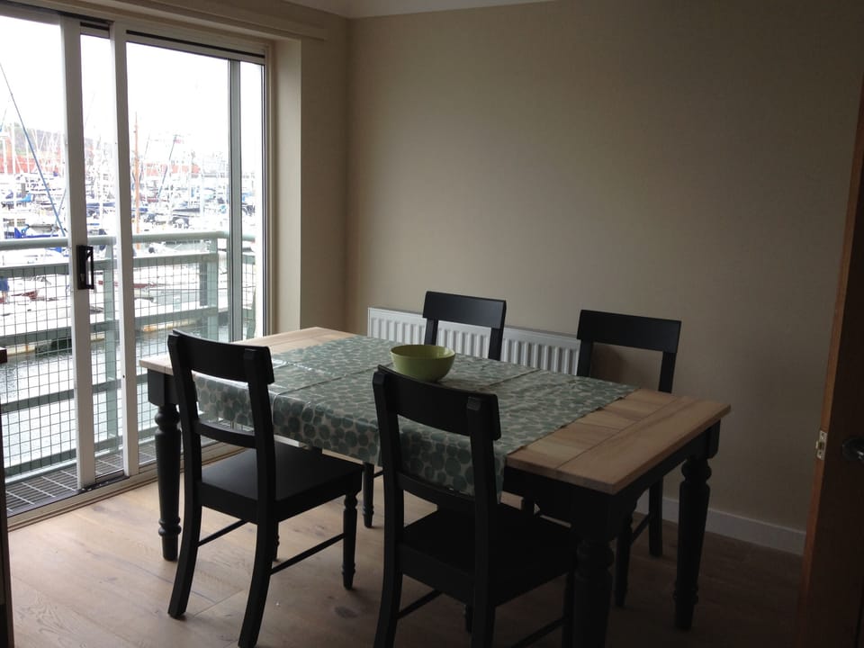 Dining area in the kitchen with sliding doors onto julliet balcony. 