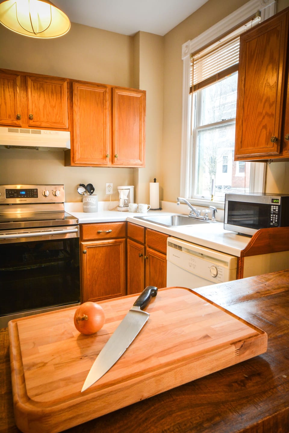 Kitchen has range, dishwasher, microwave and refrigerator