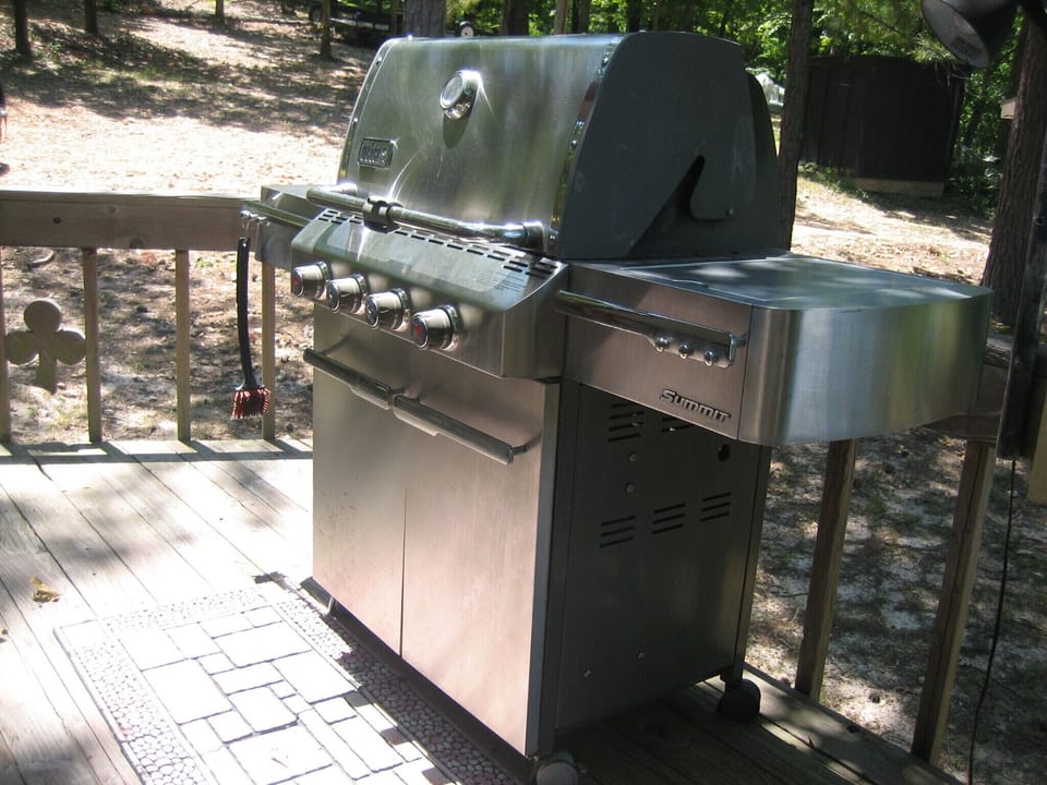 Four burner Weber propane grill.