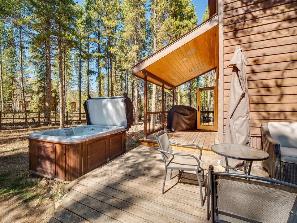 Covered deck with barbecue grill and hot tub