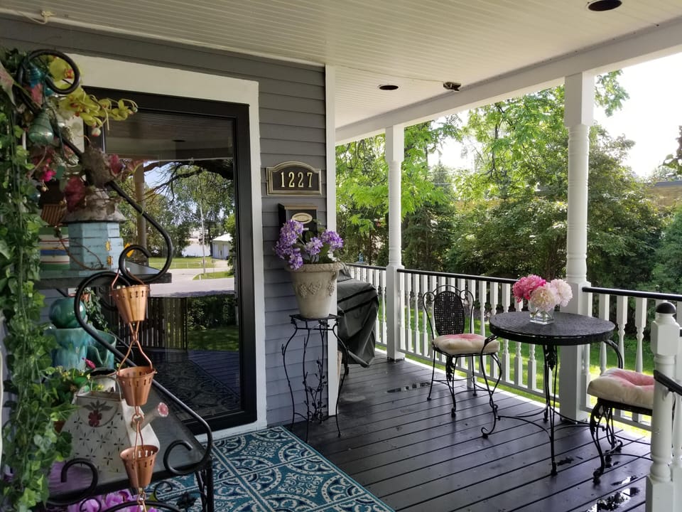 Front Entry on wrap around porch , gas grill and eating area
