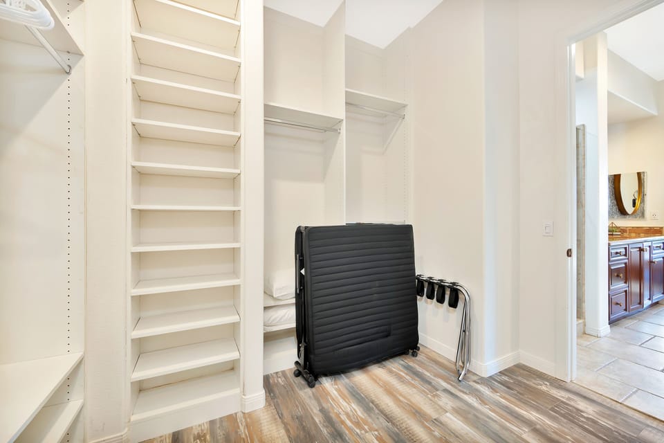 Master Bedroom walk-in closet, with roll-away