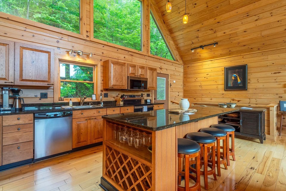 Modern kitchen equipped with a dishwasher, granite countertops, and a standard Drip-style coffeemaker, making meal preparation a delight.