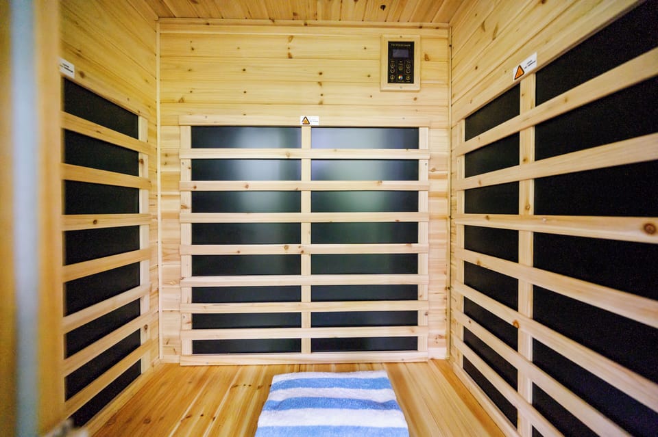 Step into your private sauna and let the soothing warmth melt away your stress, surrounded by natural wood and radiant heat for ultimate relaxation.