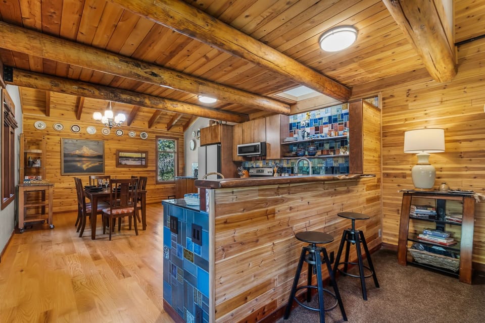 Warm wood beams and vibrant blue tile create a cozy, artisan kitchen where you'll love preparing meals and gathering with family over morning coffee or evening cocktails.