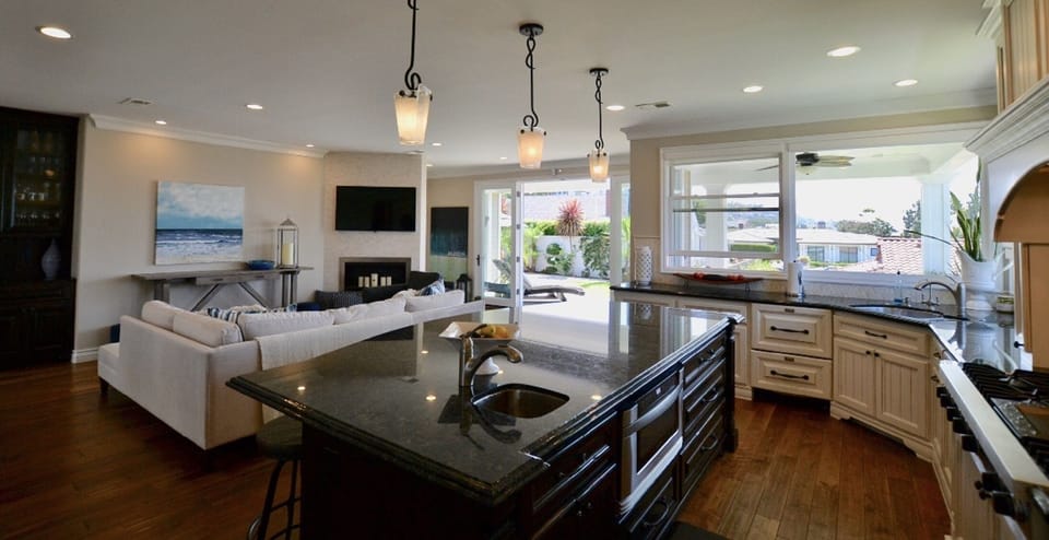 Back living room + kitchen with french doors to the backyard