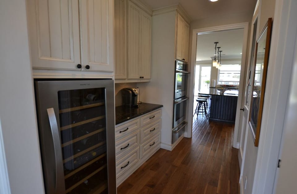 Wine fridge, coffee area, walk in kitchen pantry and oven in hallway from front