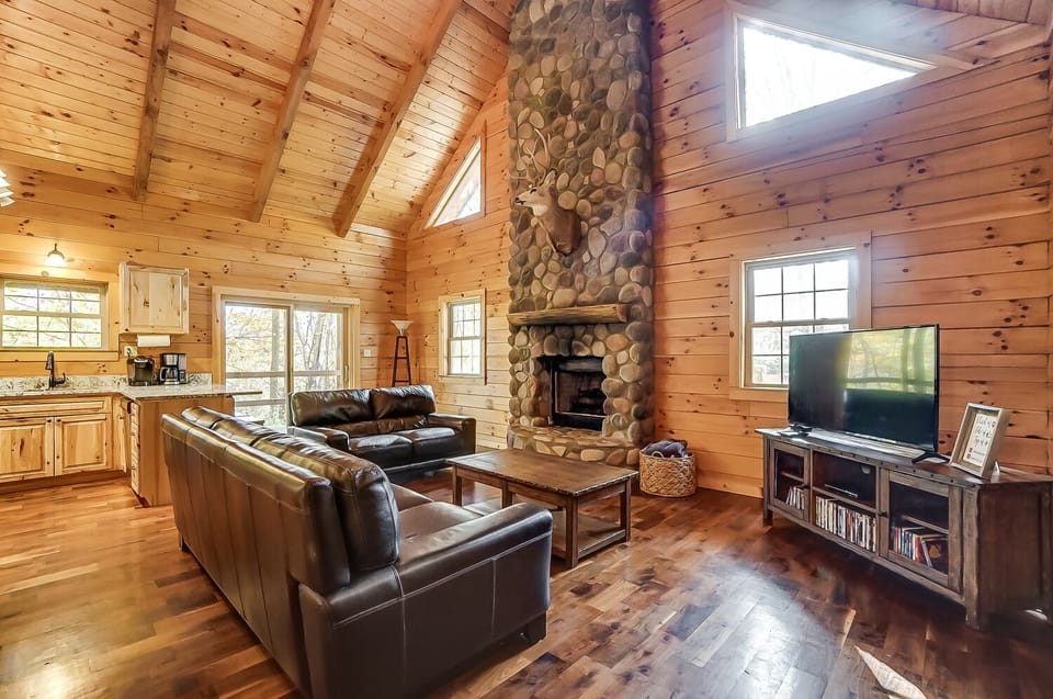 The open floor plan features living room with smart TV, cable and gas fireplace.