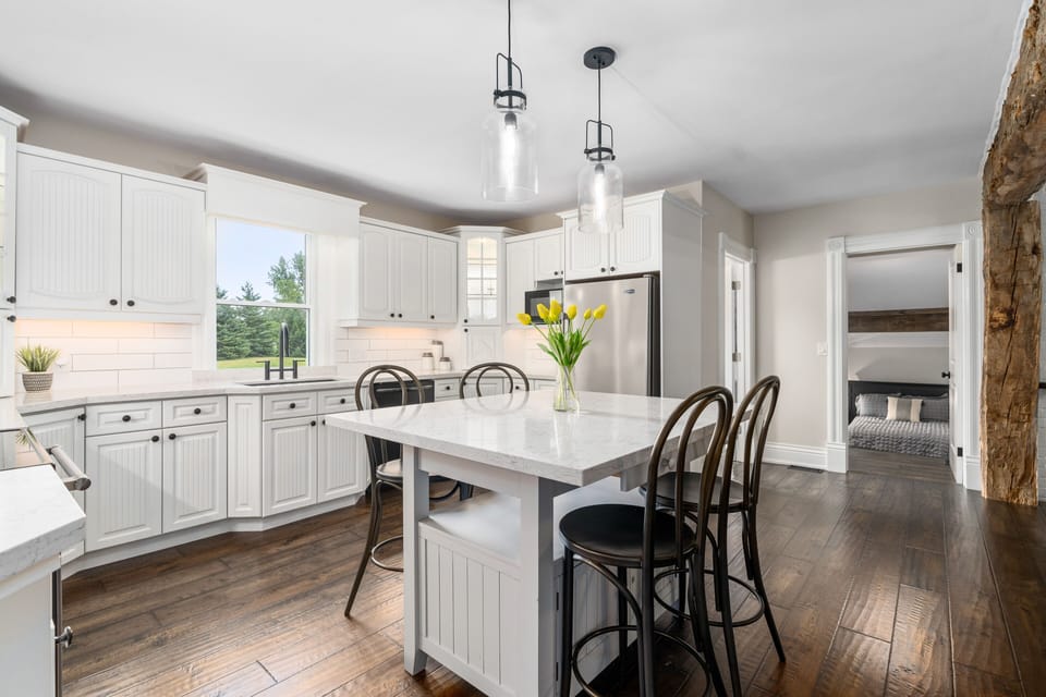 Country kitchen featuring stainless steel appliances & quartz countertops