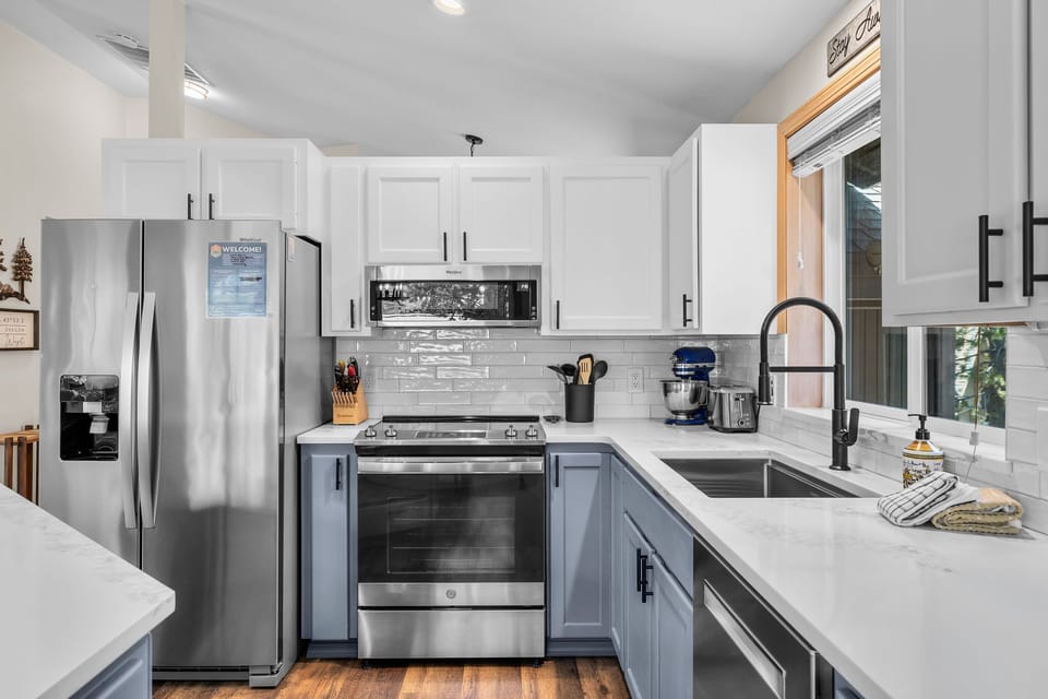 Modern, fully-equipped kitchen with stainless steel appliances and bright countertops—ready for your culinary adventures.