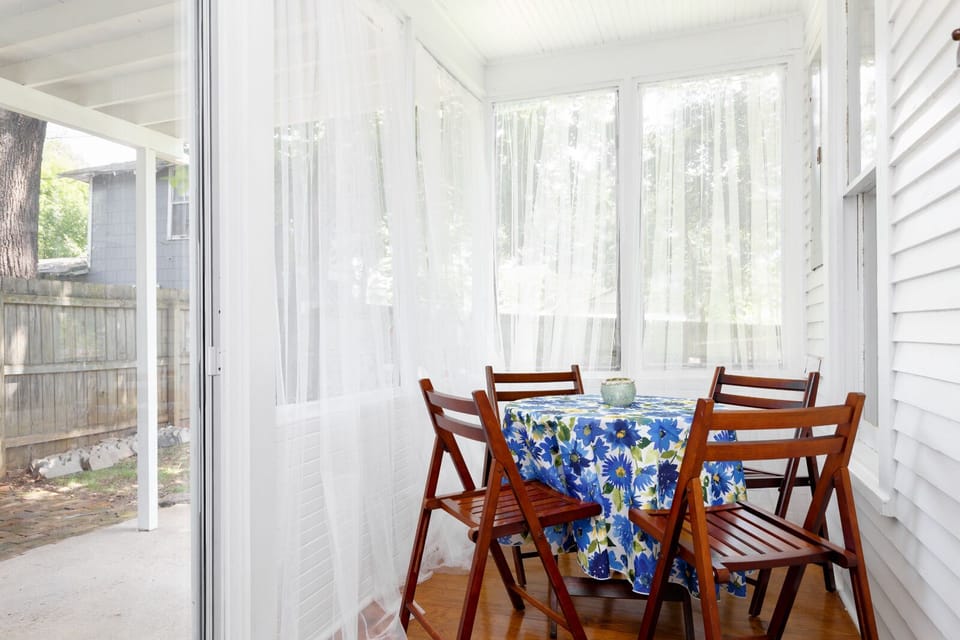 closed in back porch with seating for four.
opens into backyard.