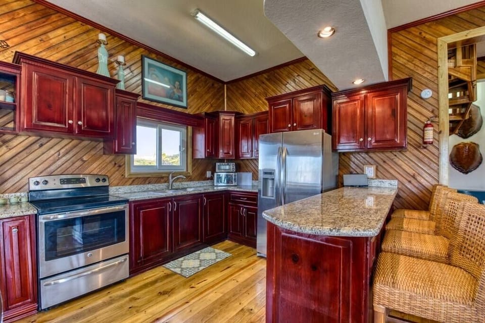 Kitchen has electric stove, microwave, toaster oven and plenty of cabinet space.