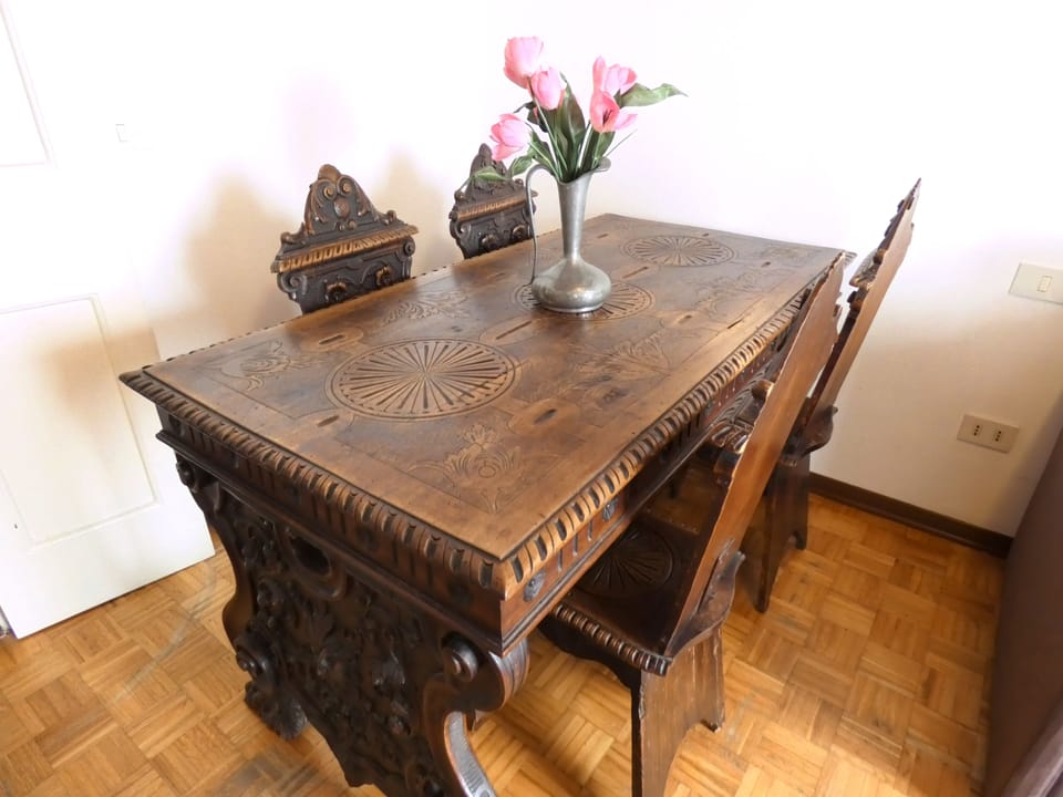 The dining area has a lovely early twentieth century inlaid table