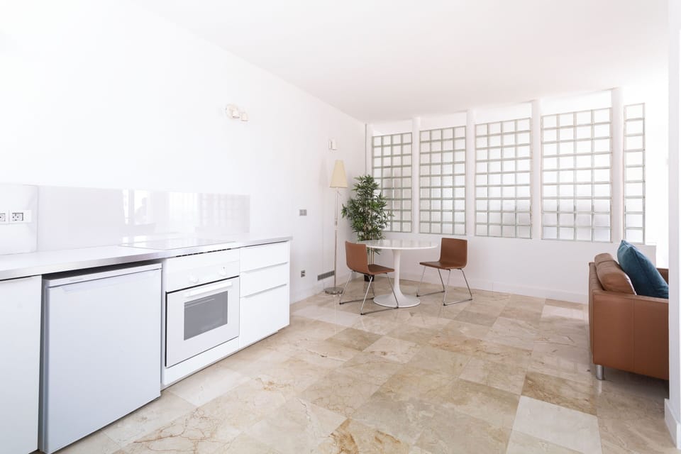 Kitchen with fridge, oven, dining table