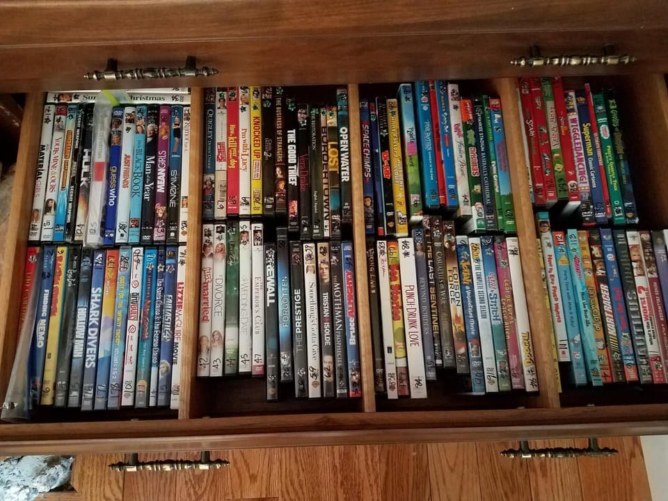 One of two drawers by TV with >100 DVDs. Selections for both kids and adults.