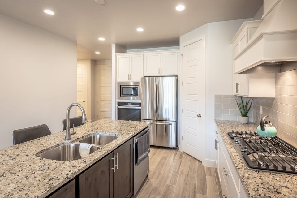 Kitchen - The kitchen is fully stocked with all the dishes, cookware, baking pans, and cutlery you will need for meal preparations and includes stainless steel appliances and granite counter tops.