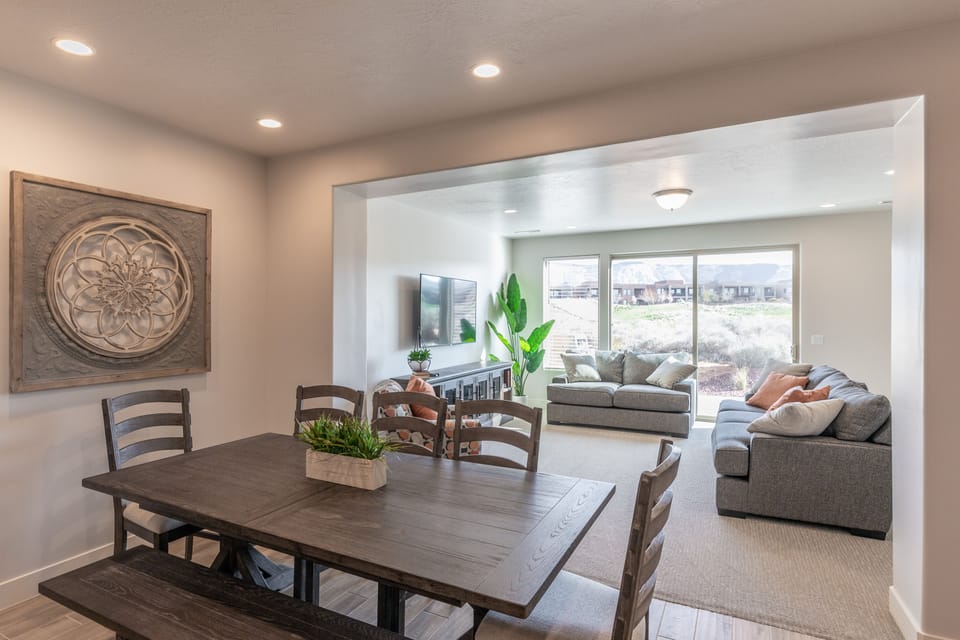 Downstairs Living Area - The living room is designed as an open floor plan and is a great gathering place for meals, games, or watching TV during your stay.