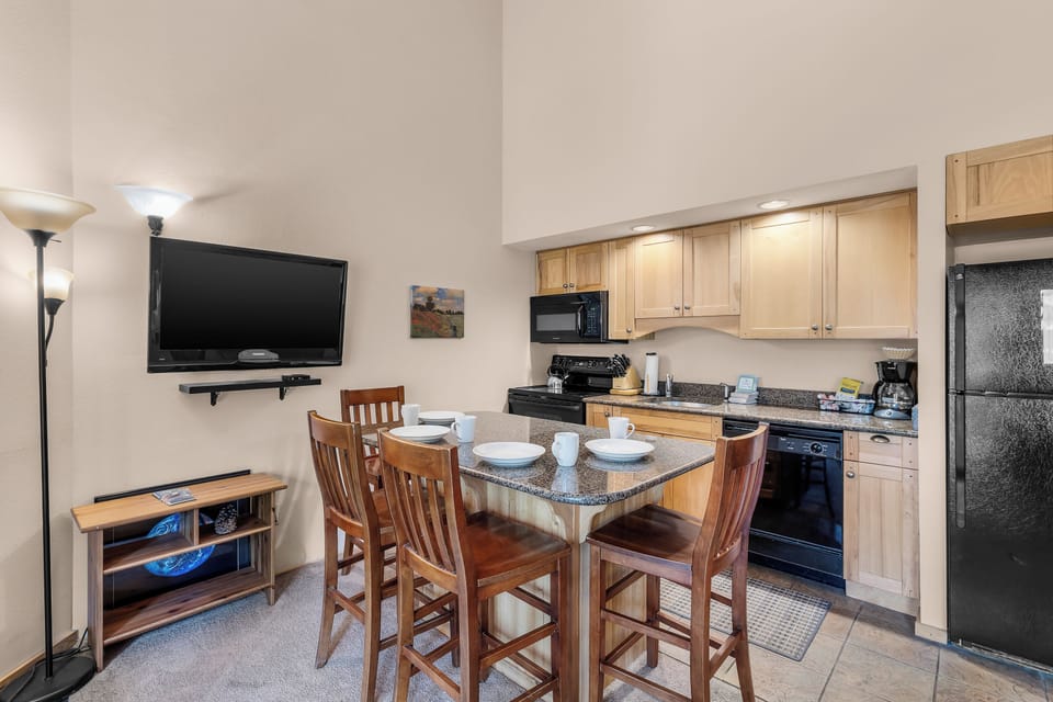 Your well-equipped kitchen invites you to prepare home-cooked meals while gathering around the granite breakfast bar. Light wood cabinetry and modern appliances make cooking convenient and enjoyable.