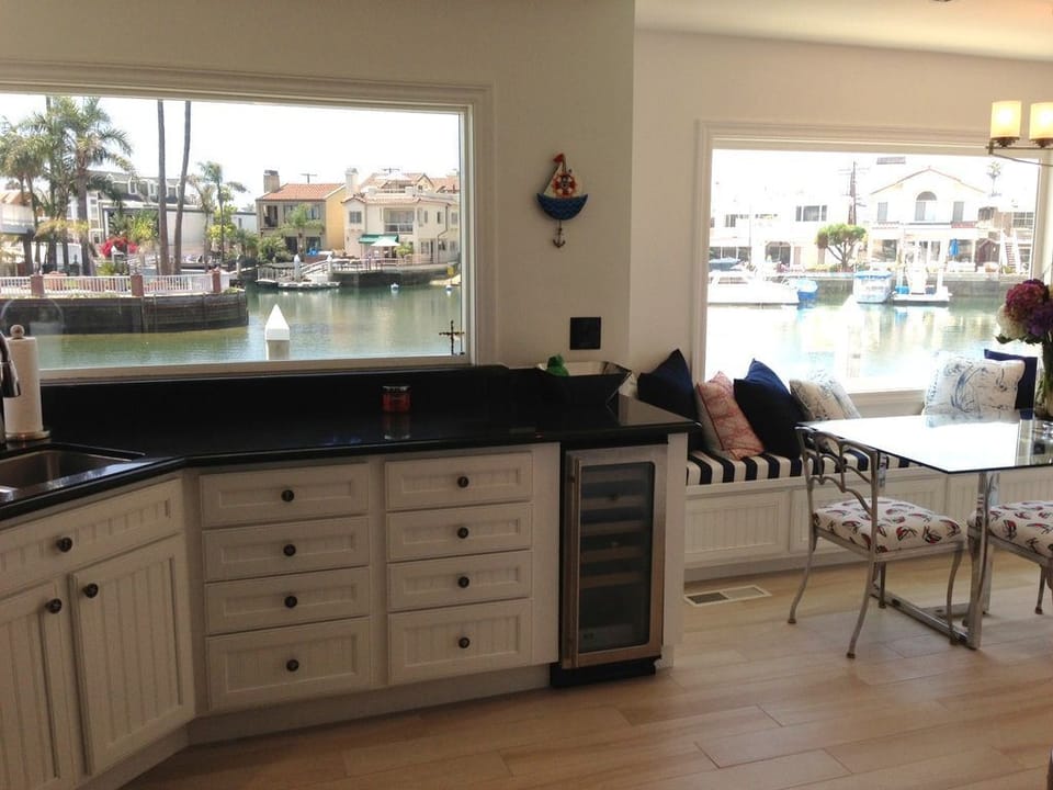 Airy kitchen has wine fridge and endless views