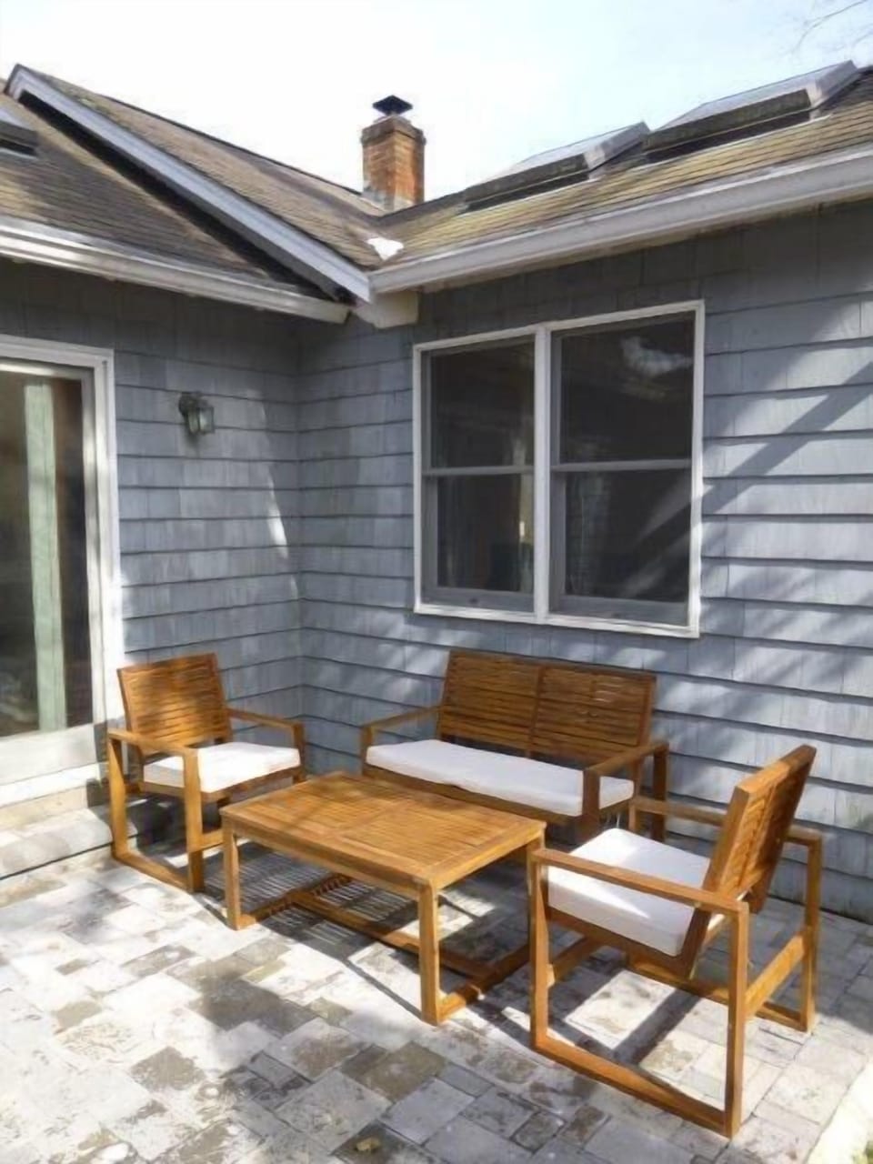 Side patio lounge set off kitchen, BBQ adjacent