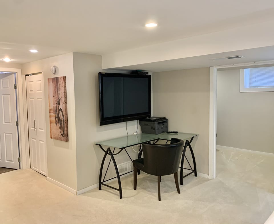 There is a designated workspace with printer and Large TV to use as a monitor. 