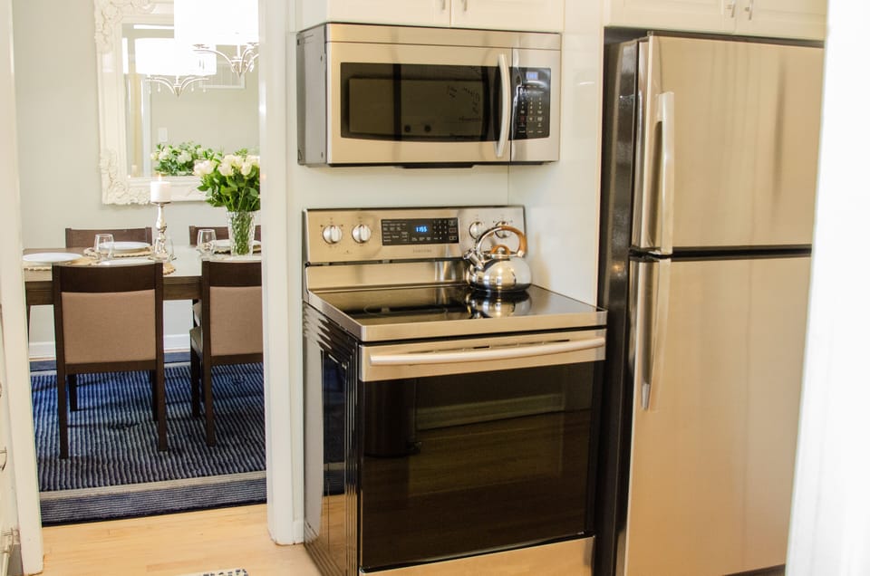 Kitchen has rice cooker, crockpot, knives, pots, frying pan, Keurig  or press. 