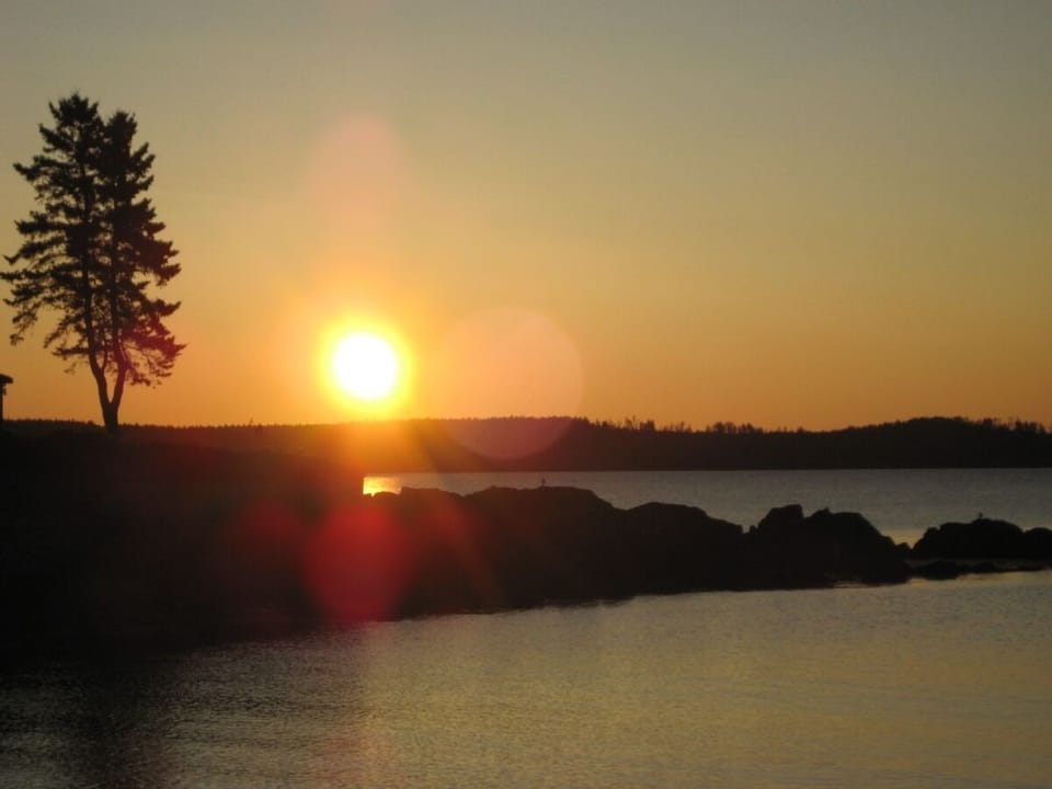 Watching the sun rising over the islands  from our beach.