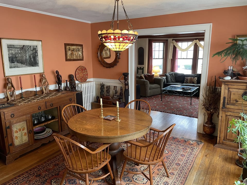 Dining Room has Large Sideboard, Table with Seating for Four & Wine Cabinet