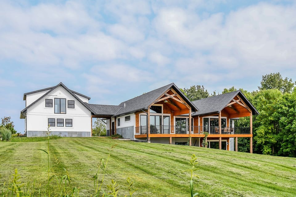 Exterior lakeside with large lawn overlooking lake.