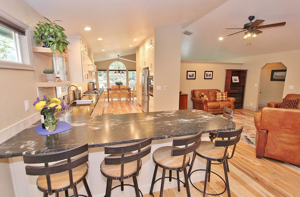 Breakfast bar with kitchen opening up to dining room.