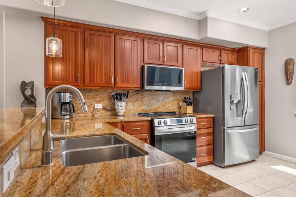 Your gourmet kitchen features granite countertops, rich wood cabinets, and stainless steel appliances for effortless meal preparation.