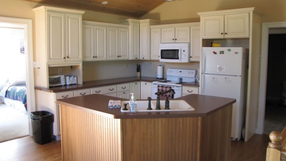 Kitchen! Plenty of cabinets and an open concept to allow you to be together.