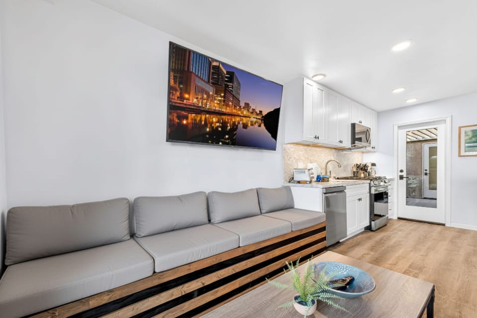 Relax in the living area with a big TV while staying connected to the kitchen, perfect for movie nights, family time, and entertaining during your beach getaway.