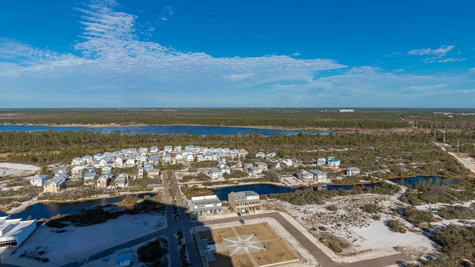 This view showcases serene natural surroundings with a glimpse of charming homes and waterways, perfect for relaxation
