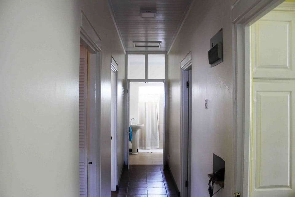 Hallway between bedroom with bathroom at end, shared by bedrooms 2 & 3.