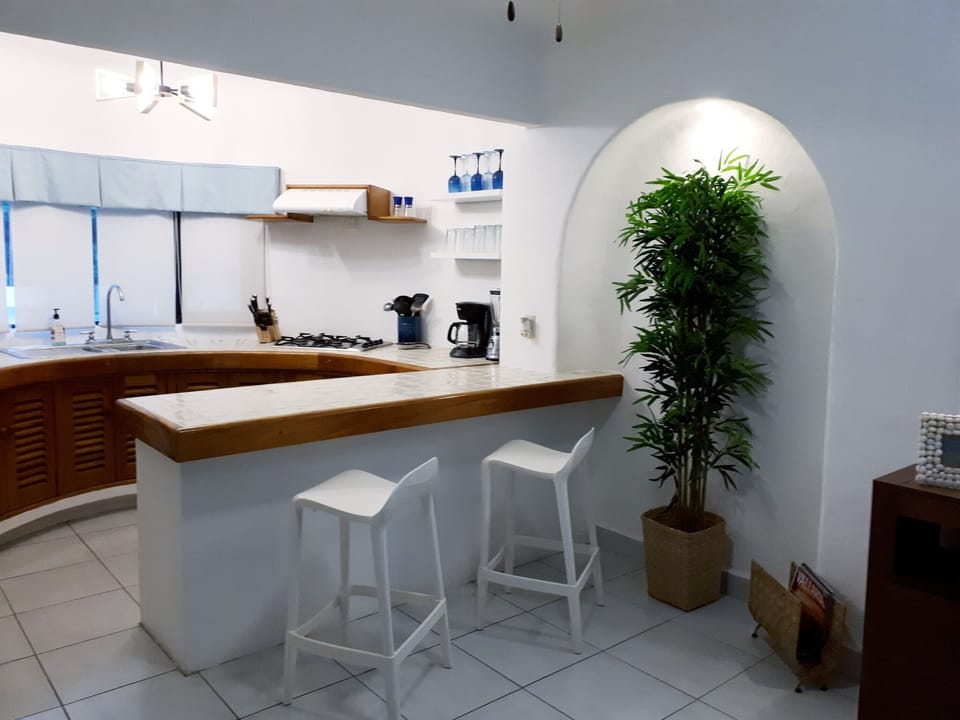 Kitchen with breakfast area and two barstools.